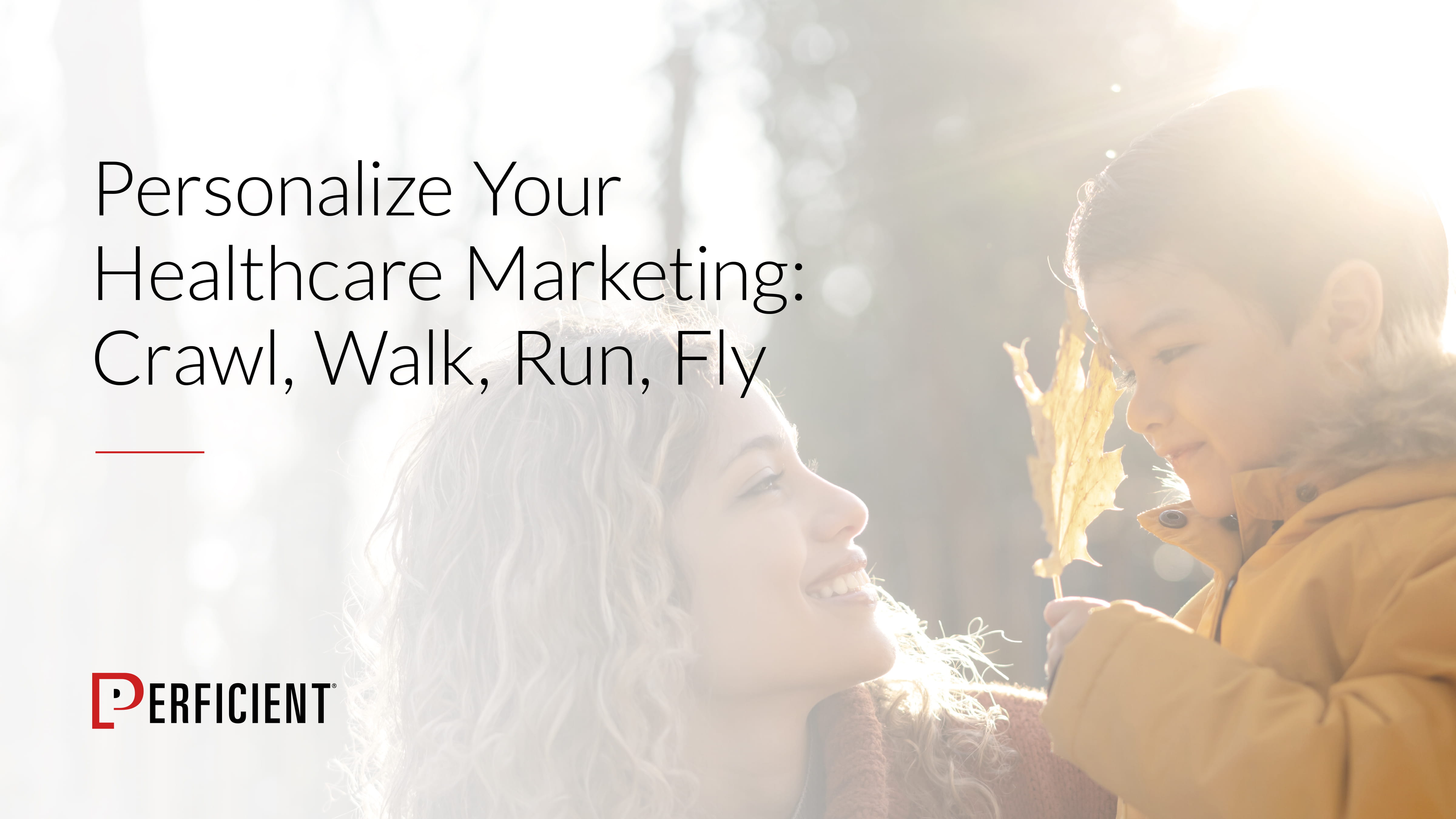 happy woman looking at a young boy in outdoor sunlight