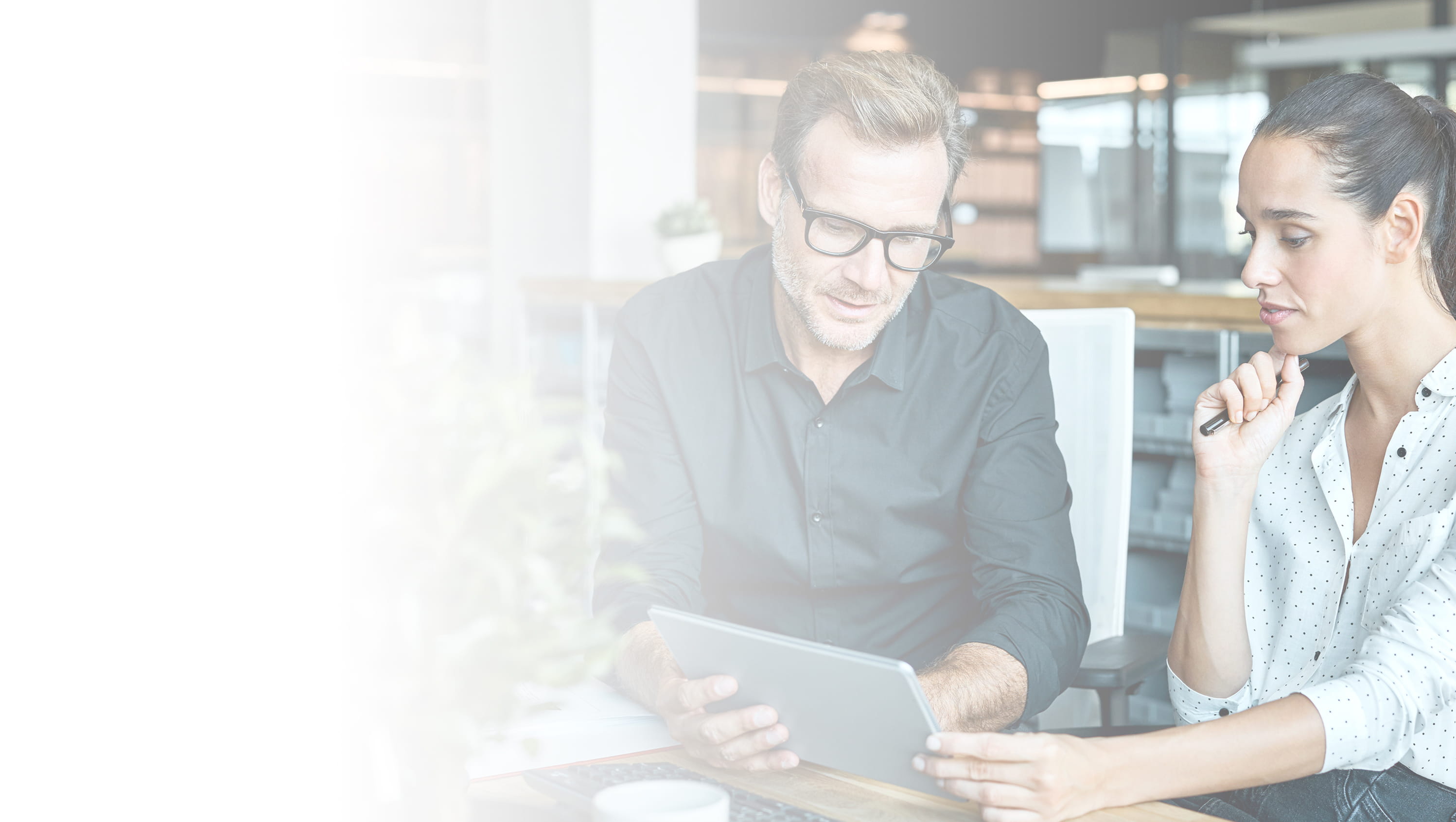 Two professionals working on a tablet. Gradient image.