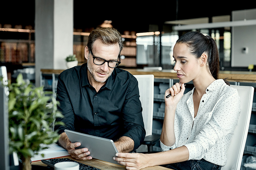 A man and women looking at a tablet