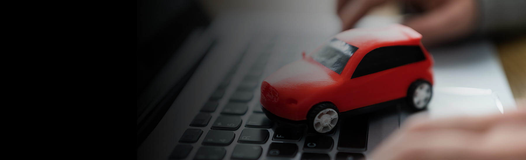 Toy Car sitting on top of a laptop