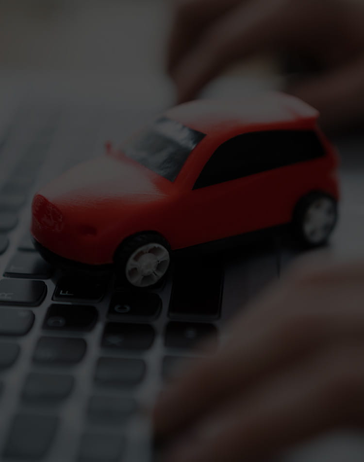 Toy Car sitting on top of a laptop