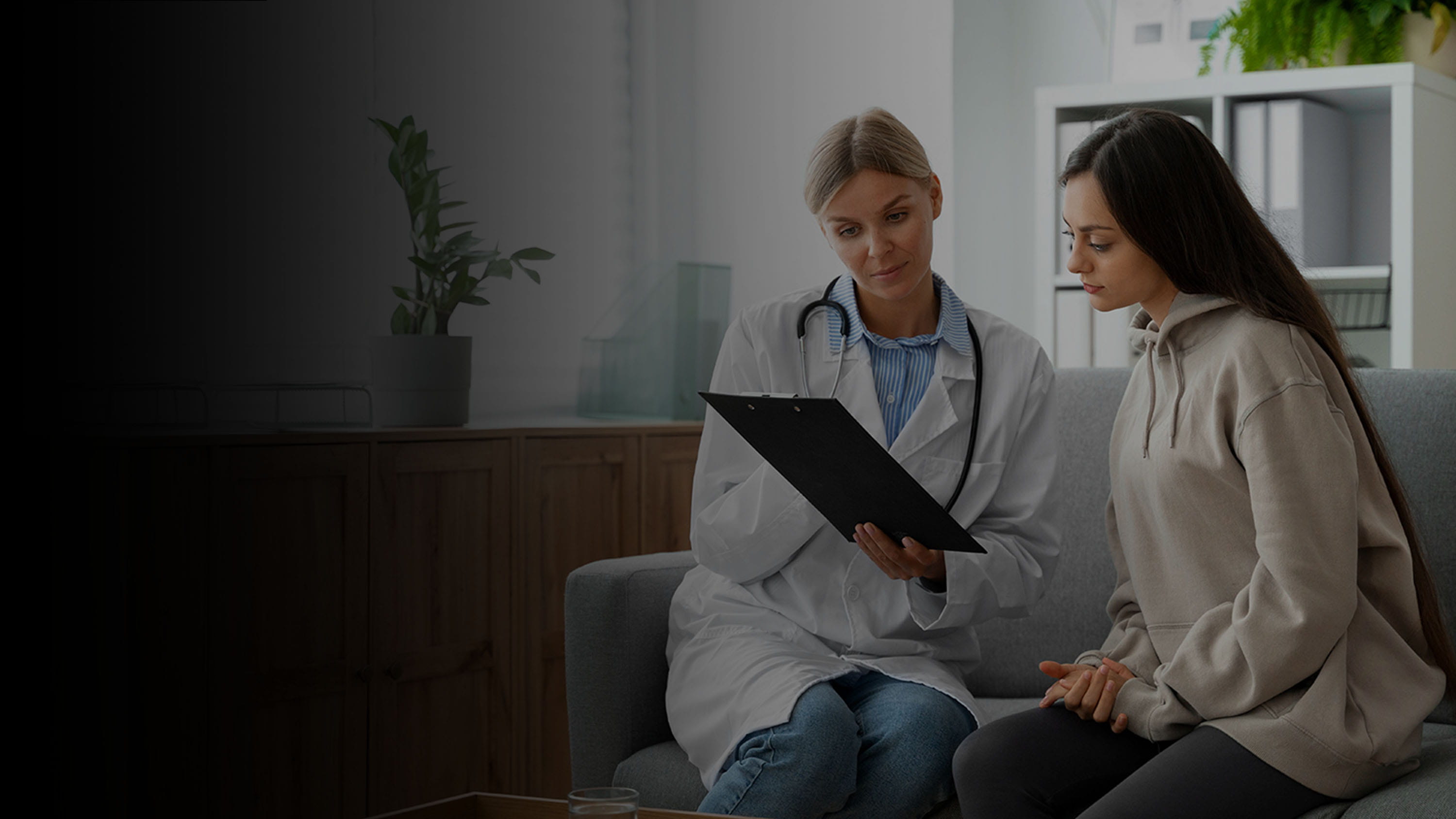 A doctor and patient going over information on a tablet.