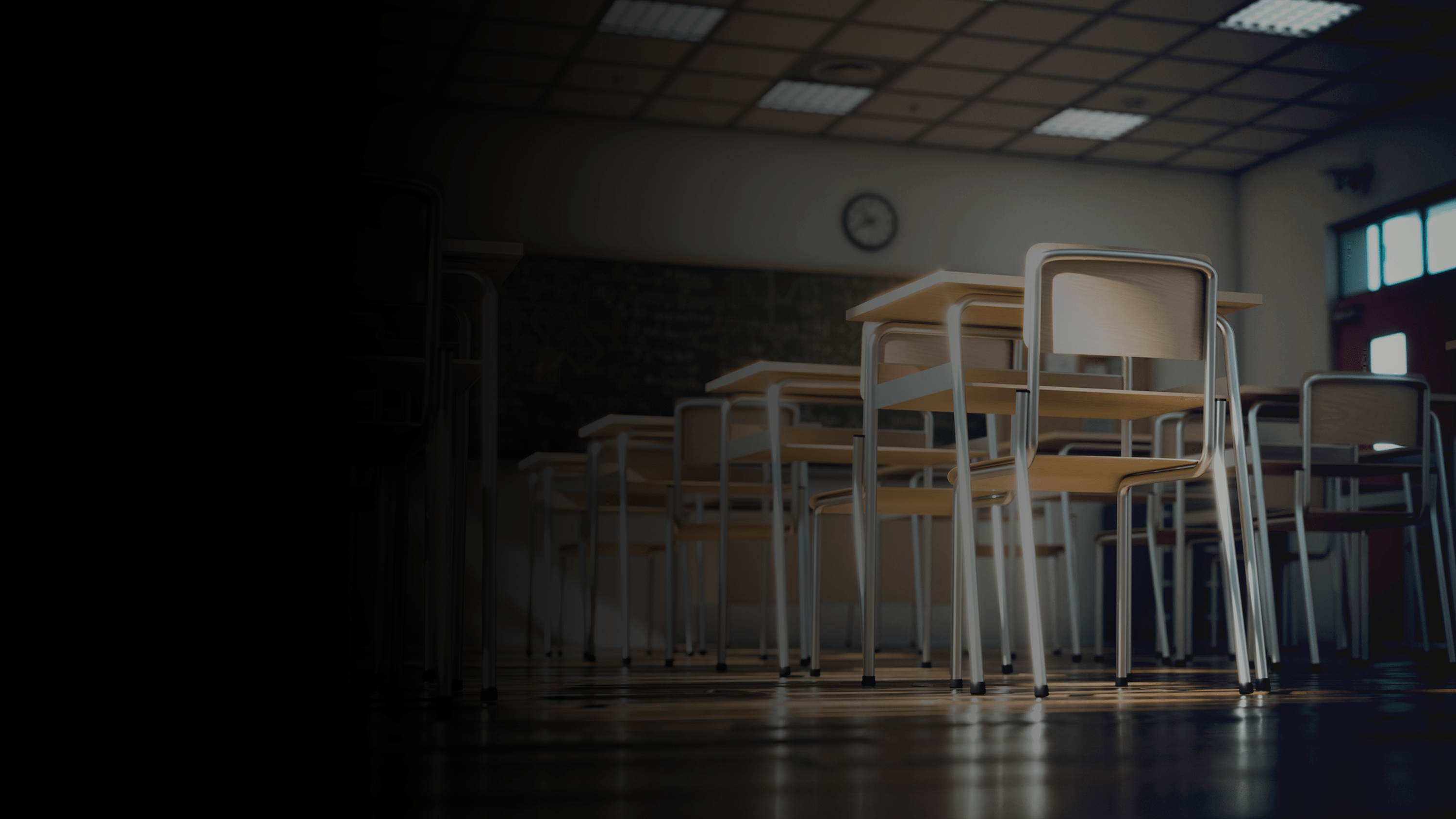 An empty classroom full of desks and chairs.