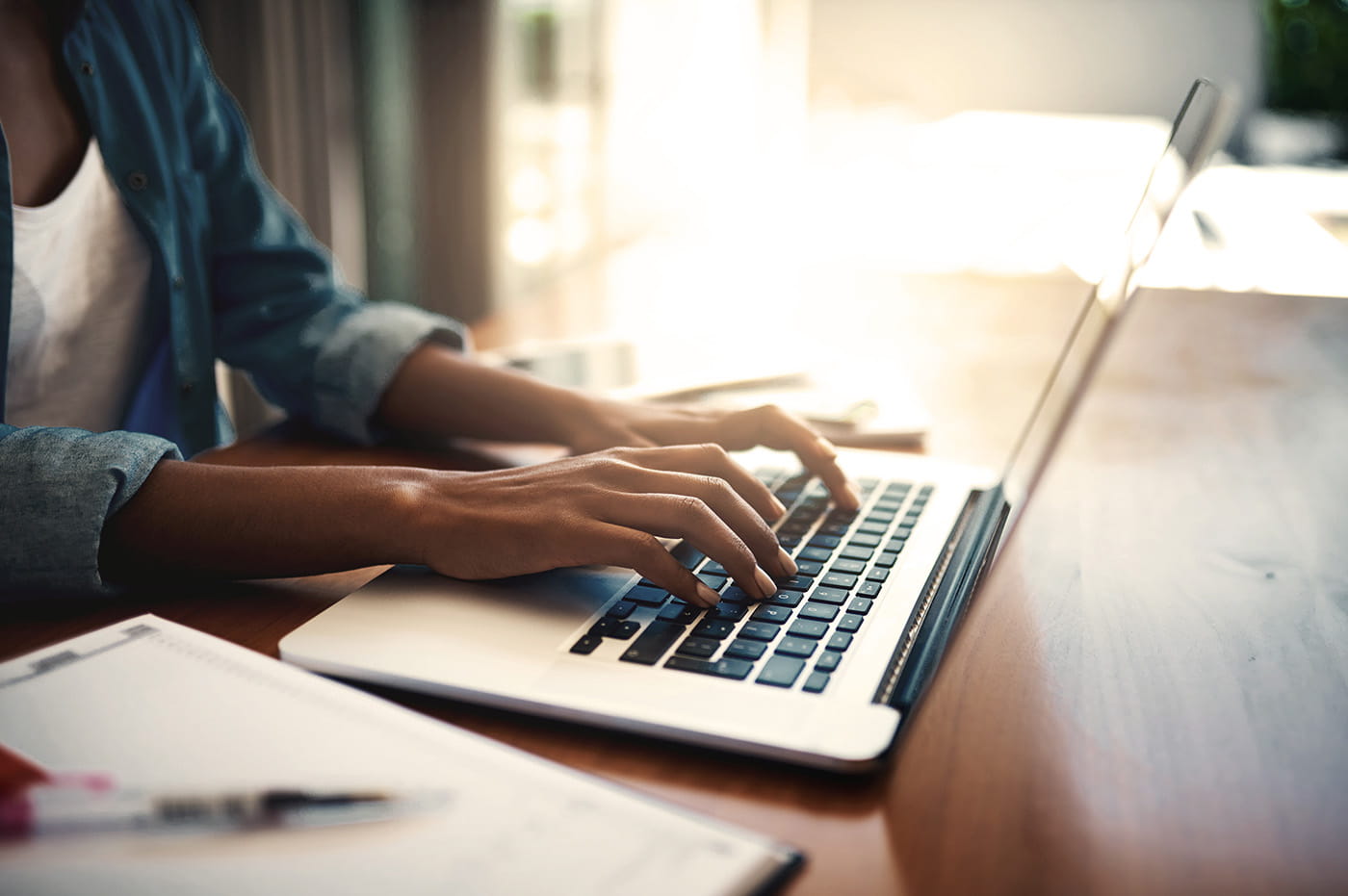 A woman working on a laptop.