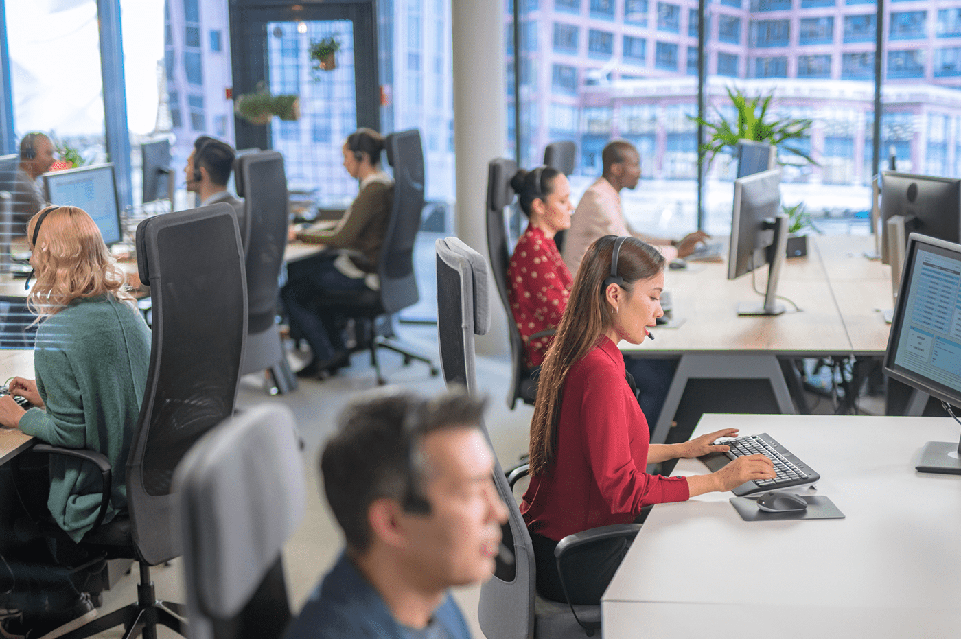 A group of people all working at desks with computers