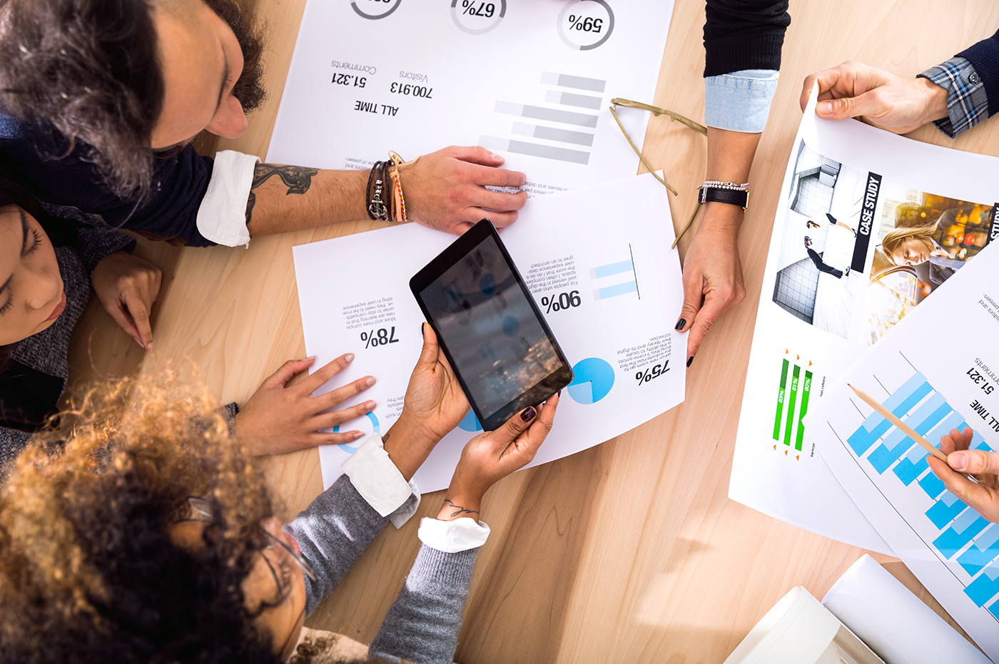 A group of colleagues looking at several sets of data.