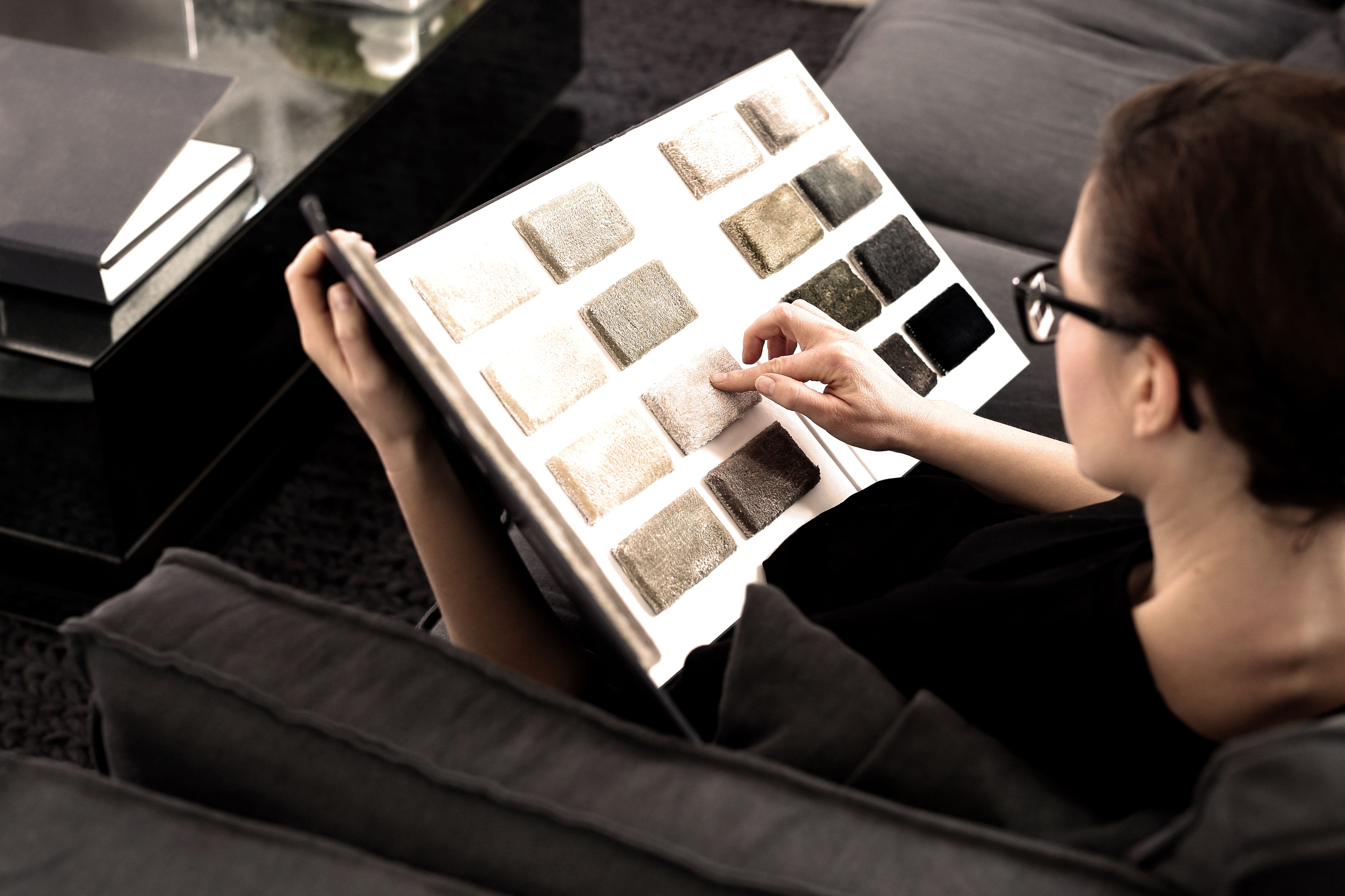 Someone looking at rug and carpet samples.