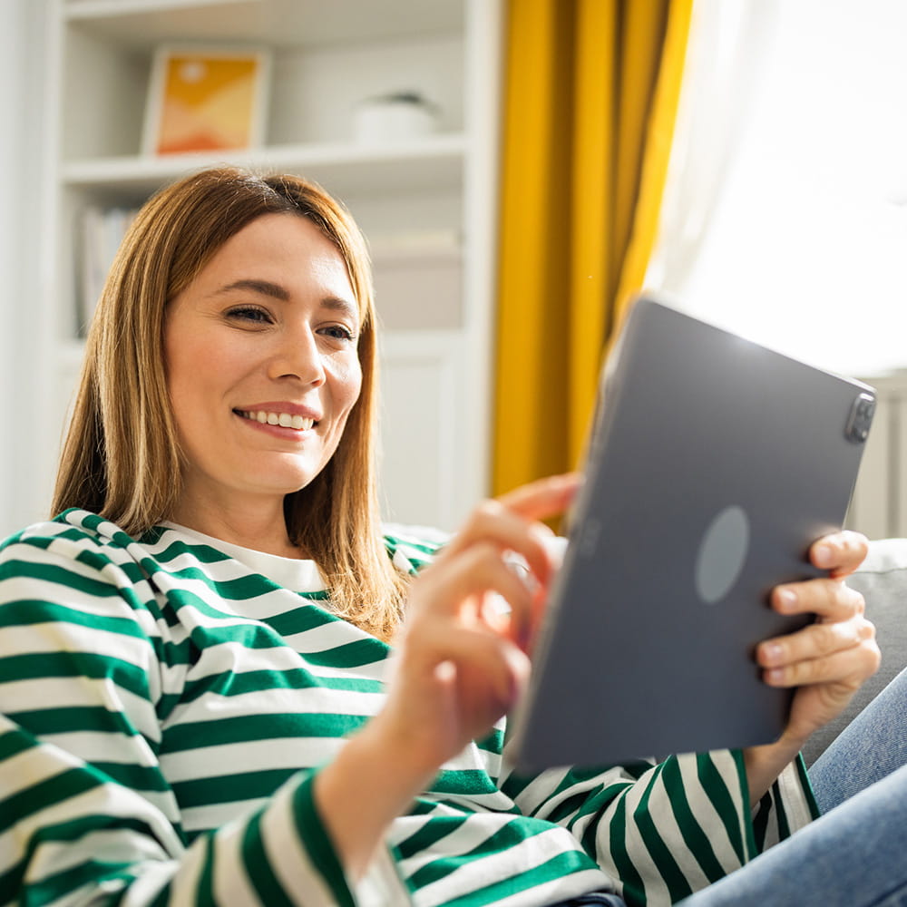 A woman using a tablet.