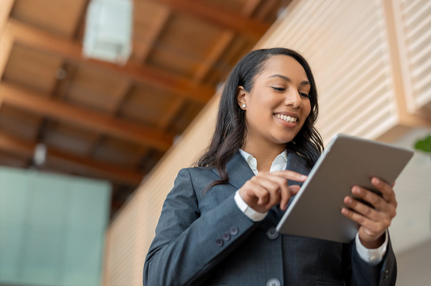 A professional woman working on her tablet.