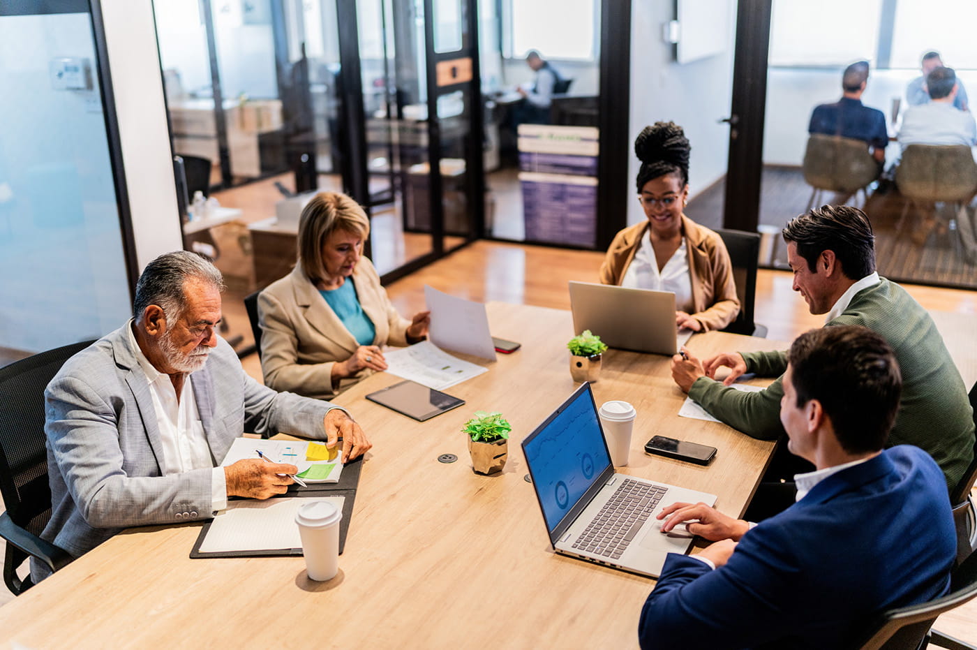 People working and sitting around a table