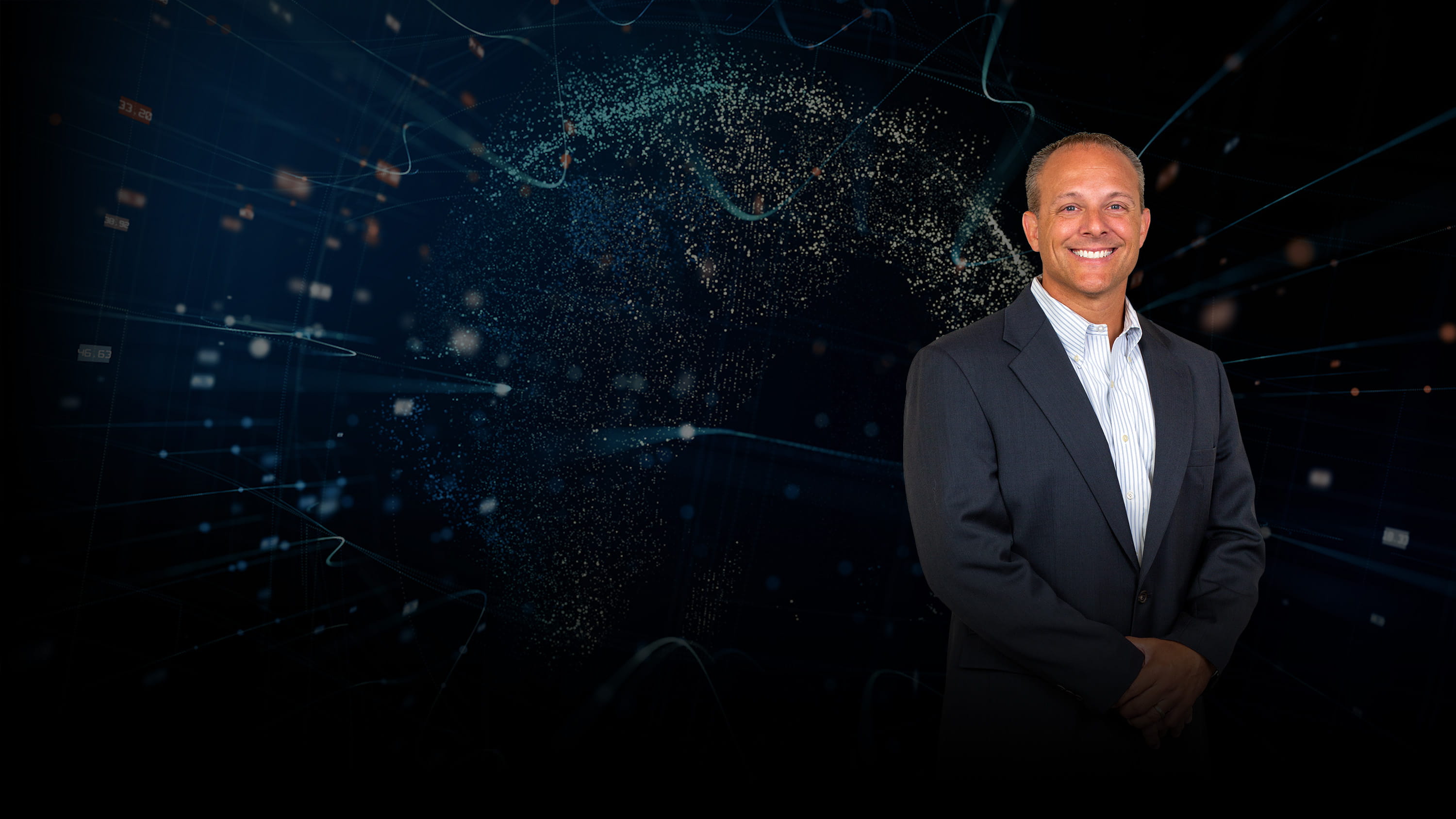 Jason Hudnall in front of an abstract background.