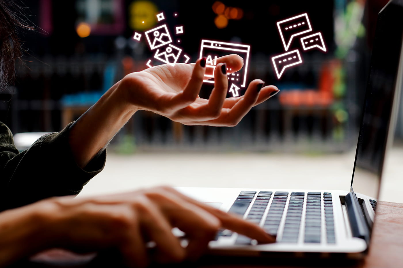 Someone typing on a laptop with various digital symbols.