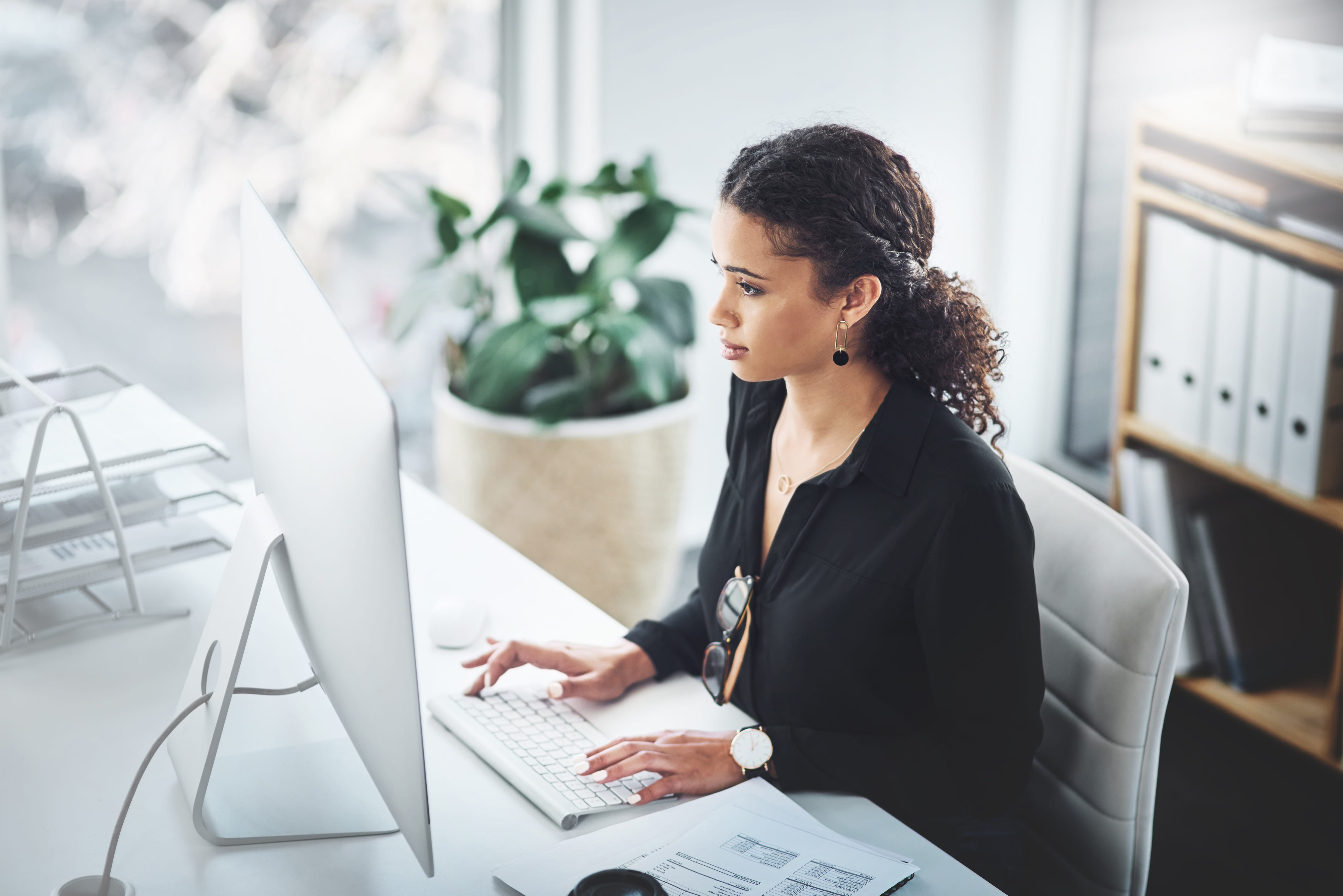 Business woman working at a desktop computer.